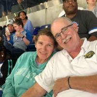 a couple holding hands and smiling